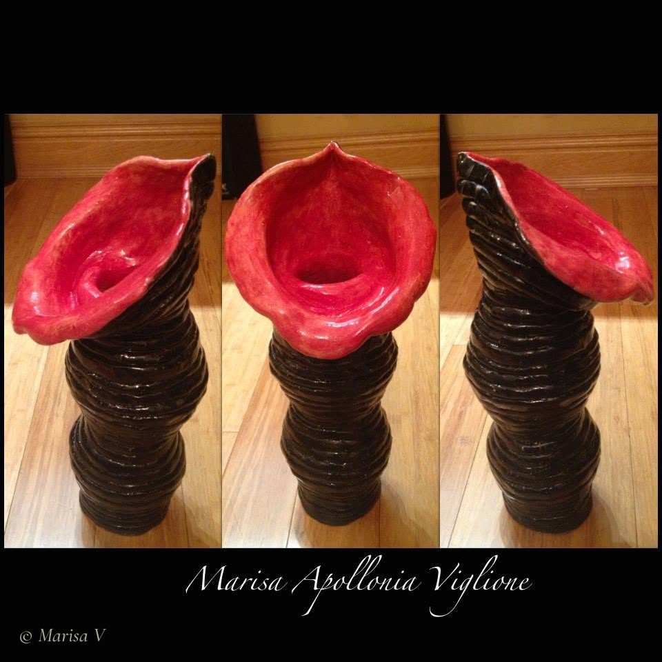 Tall black coil-built ceramic vase topped with a red calla-shaped bloom, seen from three angles.