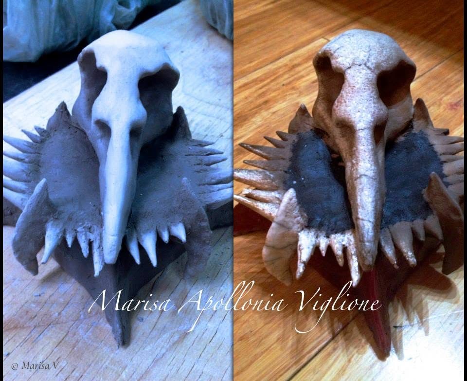 Ceramic sculpture: a white long-beaked bird skull on a black collar bristling with spikes and fangs, shown before and after firing.